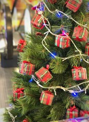 decorated christmas tree in yellow lights background. traditional new year holiday decoration, intim