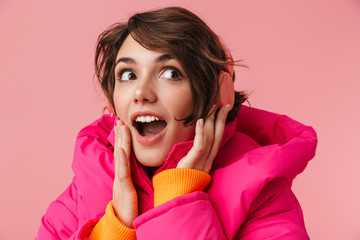 Canvas Print - Portrait of young excited woman using headphones and smiling