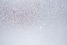 Ice And Frost On A Window Pane In Winter. Weather Forecast: Cold, Frost, Cooling. Abstract Light Blank Background Or Wallpaper. Harsh Season. Low Contrast