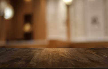 Empty dark wooden table in front of abstract blurred bokeh background of restaurant . can be used for display or montage your products.Mock up for space.