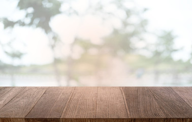 Empty dark wooden table in front of abstract blurred bokeh background of restaurant . can be used for display or montage your products.Mock up for space.