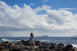 © Tripodland - Women with summer clothes on volcanic rocks and blue ocean