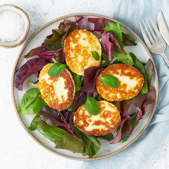 Wall Mural - Cyprus fried halloumi with salad mix, beet tops. Lchf, pegan, fodmap, paleo, scd, keto, ketogenic diet. Balanced food, clean eating recipe. Top view, white background