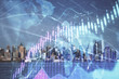 © peshkova - Forex chart on cityscape with skyscrapers wallpaper double exposure. Financial research concept.