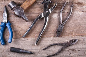 Wall Mural - A lot of old weeping tools on a wooden board, hammer, tongs