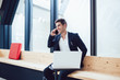 © GalakticDreamer - Happy caucasian prosperous director in formal trendy outfit laughing during mobile phone talk enjoying conversation,cheerful owner of business making call during work in office with technology.