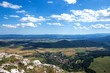Panoramic views of the sky above Hohe Wand. Above are beautiful clouds in the blue sky, and below are forests and fields.