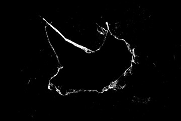 Aufkleber - hole in the glass with cracks isolated on a black background.