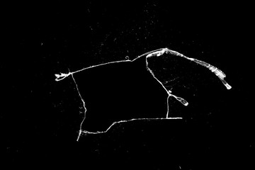 Aufkleber - hole in the glass with cracks isolated on a black background.