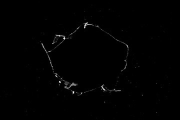 Aufkleber - hole in the glass with cracks isolated on a black background.