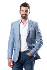 A young man wearing a Blazer in blue jeans on a white background