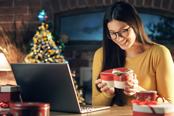 Young woman holding an envelope with a Christmas card