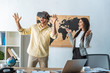 © LIGHTFIELD STUDIOS - smiling travel agent looking at excited man using vr headset