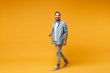 © ViDi Studio - Funny laughing young bearded man in casual blue shirt posing isolated on yellow orange wall background, studio portrait. People sincere emotions lifestyle concept. Mock up copy space. Looking camera.
