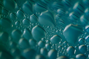 Wall Mural - macro close-up photo of condensed water drops on transparent clear glass surface with extreme depth creating a  translucent and abstract pattern and effervescent and freshness copy space background