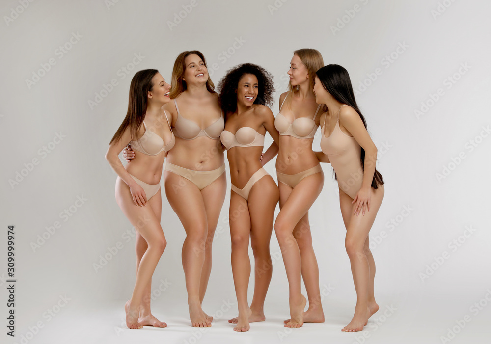 Group of women with different body types in underwear on light background - obrazy, fototapety, plakaty 