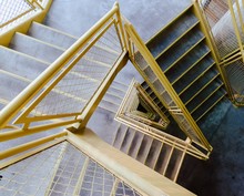 High Angle Shot Of A Stairway With Yellow Railings