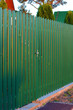 Green metal fence a with wicket sunset lihgts