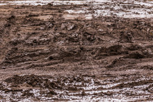 Dirty Mud Road Background At Winter With Selective Focus And Blur