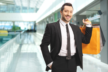 Young man with shopping bags in a mall