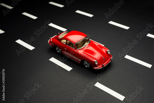 Fotomural Top and front view of a Porsche Carrera 2 toy model car on a blue background