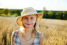 Portrait Of Smiling Girl Wearing Straw Hat