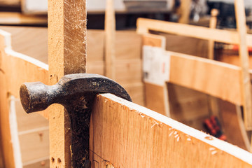 Hammer hanging on a piece of wood in a workshop