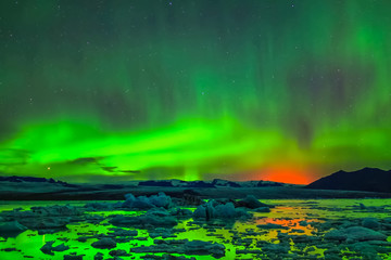 aurora borealis in night northern sky. ionization of air particles in the upper atmosphere.