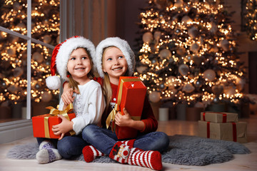 Canvas Print - Cute little children with Christmas gifts at home