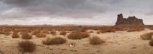 Navaho Nation Covered In Dust And Dry Grass With Rocks On The Background Under A Cloudy Sky