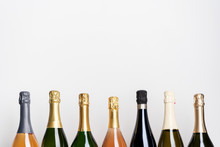 Collection Of Various Champagne Bottles On White. Pink, White And Green Bottles. Sparkling Wine.