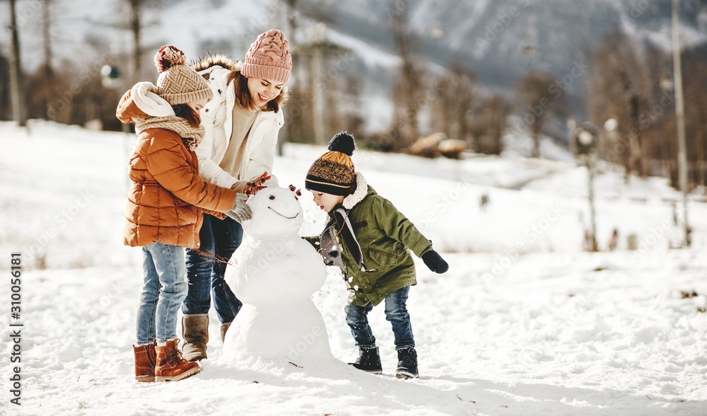 happy family mother and children having fun on winter walk - obrazy, fototapety, plakaty 