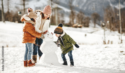 Fotomural happy family mother and children having fun on winter walk