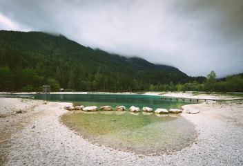 Beautiful tranquil landscape of Jasna lake in cloudy day. Julian alps, Slovenia