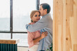© GalakticDreamer - Married couple hugging standing at home