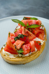 Poster - bruschetta with tomatoes and cheese on grey table