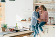 © GalakticDreamer - Loving young couple hugging in kitchen