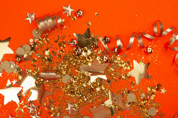 Wall Mural - Golden sparkles on coral background. Holiday concept.