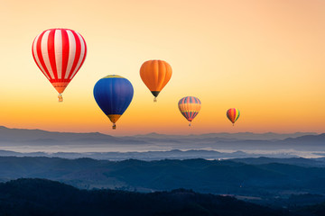 Colourful hot air balloons flying over the mountain