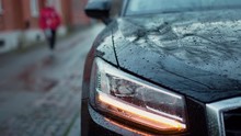 Person Out Of Focus Walks Towards A Parked Car And Unlocking It In Slowmotion On A Cloudy And Overcast Day In Sweden.