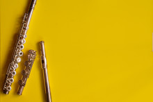 Top View Flute Traverse Over Yellow Background. Music Concept Flutist Player.