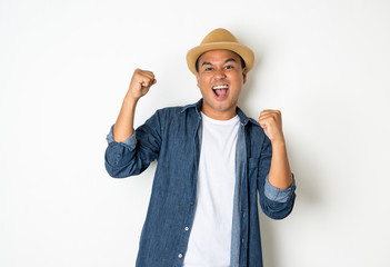 Asian men aged around 30 wearing hats and jeans feeling happy celebrate with two hand stretch on white background.