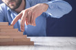 © andranik123 - Male fingers climbing stairs on wooden blocks.
