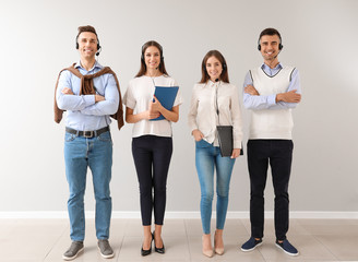 Canvas Print - Team of technical support agents on light background