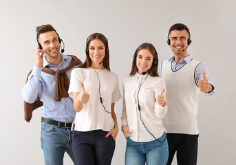 Canvas Print - Team of technical support agents on light background