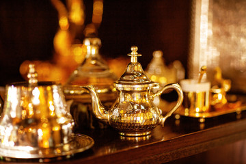 Arabian cup and teapot of gold on the eastern market. Oriental tea