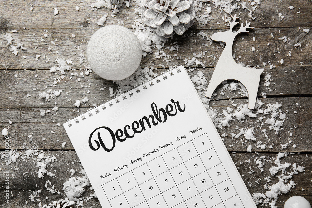 Christmas decor, snow and calendar on wooden background