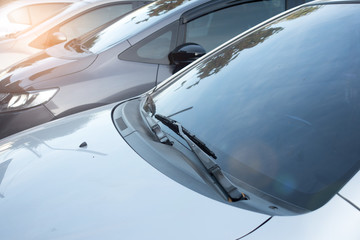 Close-up  front glass, window of the car and the side left mirror  on the street