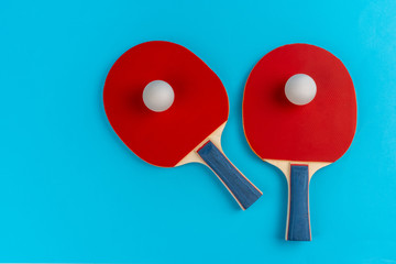 Wall Mural - Red ping pong racket on a blue background