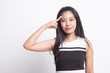 © halfbottle - Beautiful young Asian woman holding fingers in gun gesture